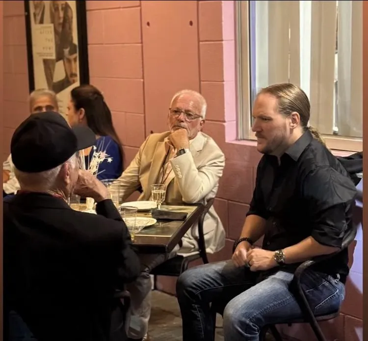 Team members and partners dining together at a restaurant table
